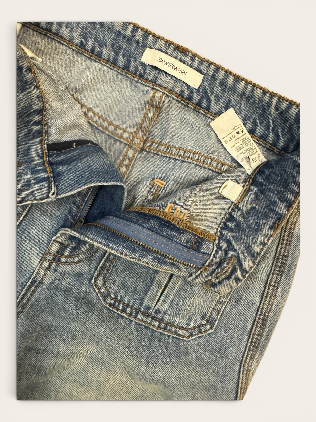 Sustainable Style Studio light blue denim high-waisted wide-leg jeans with fading and whiskering.