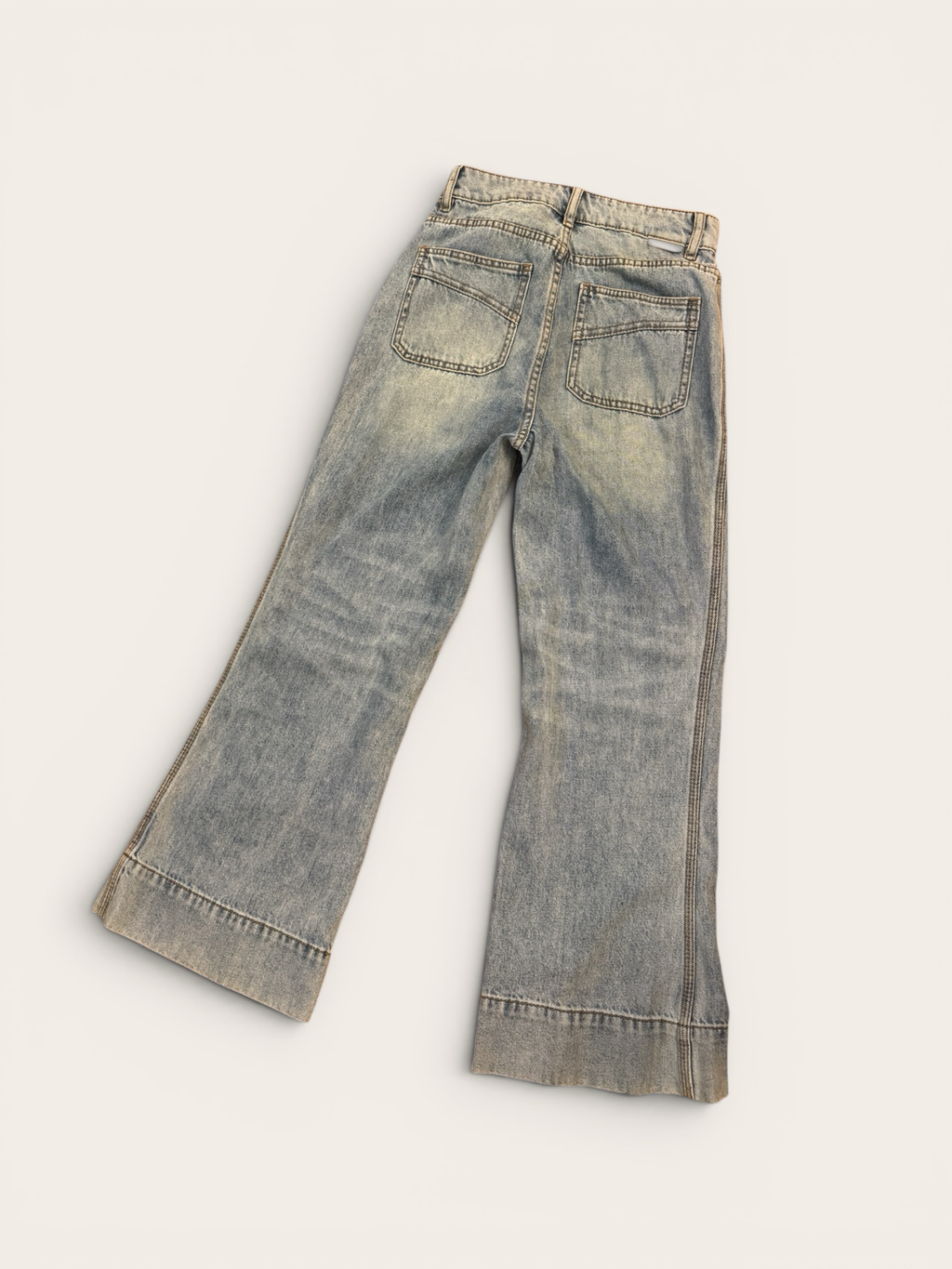 Sustainable Style Studio light blue high-waisted wide-leg denim jeans with vintage wash and flare.