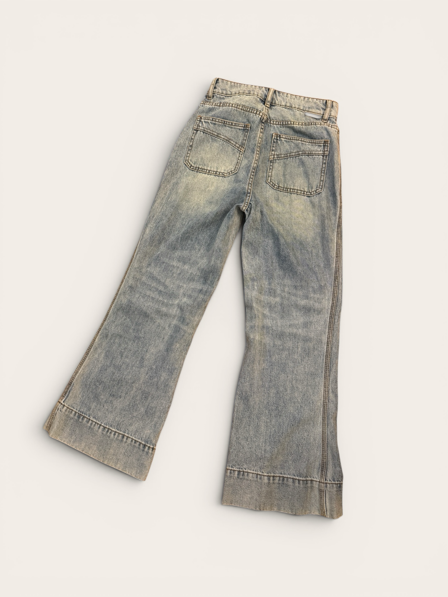 Sustainable Style Studio light blue high-waisted wide-leg denim jeans with vintage wash and flare.